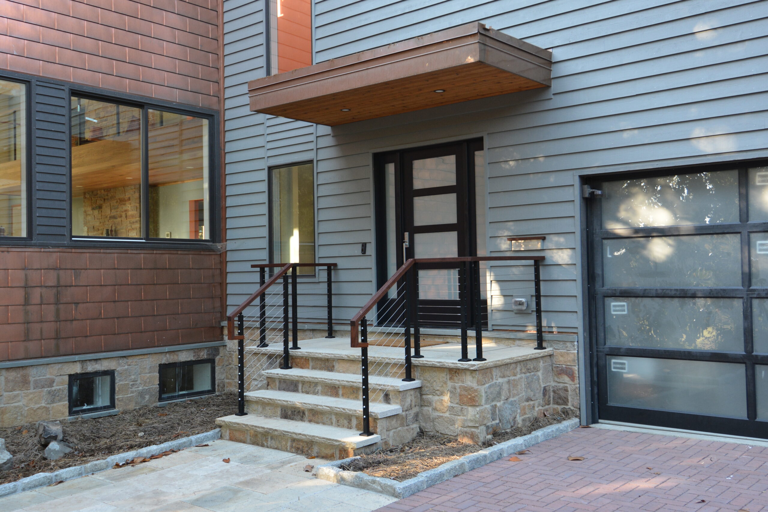 House with natural stone veneer installed on the front steps