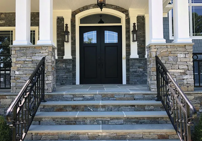 Stone veneer on stairs and columns of a residential entry way