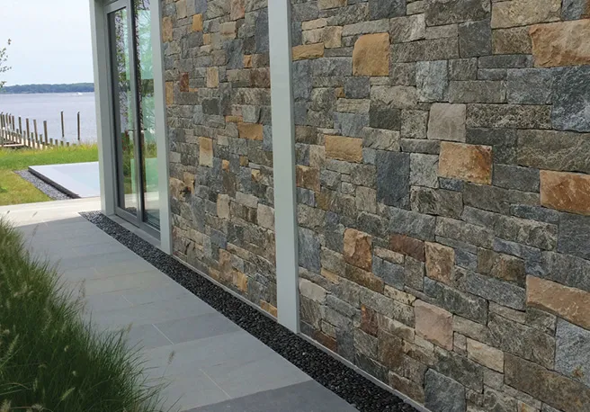 Stone veneer on the side of a waterfront home